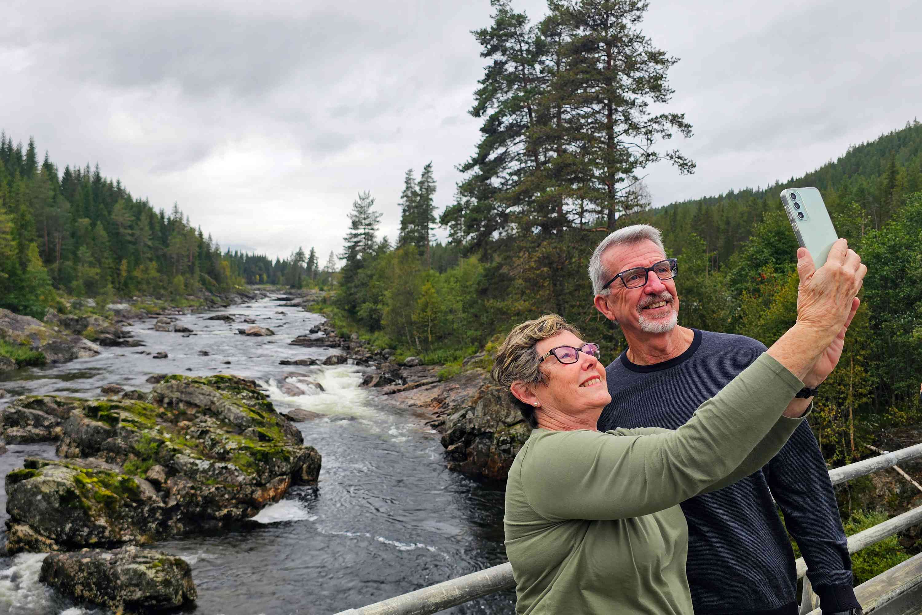 Lovely couple taking photos at the Fjords, Norway by Dennis Bunnik